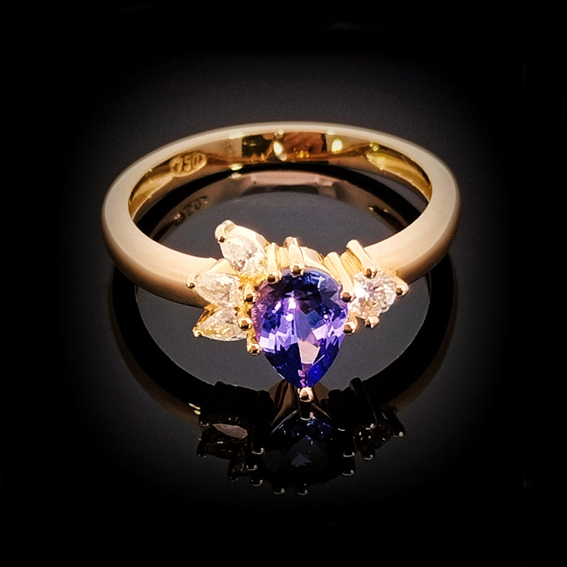 18ct Yellow Gold Ring set withTanzanite & Diamonds This beautiful ring is set with a quality tanzanite cut in a pear shape and accented with diamonds. TDW=0.20cts