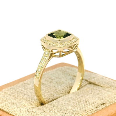9ct Yellow Gold Peridot & Diamond-set Ring This cluster dress ring is bezel-set with a 1 carat cushion-cut Peridot in the centre and surrounded by 15 points of Round Brilliant Cut Diamonds as well as down the shoulders. Peridot= 1.00ct Cushion Cut TDW= 0.15cts J-K/Si RBCs