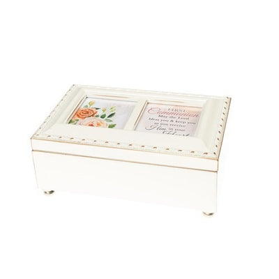 This First Communion music box plays Schubert’s “Ave Maria”. It has a dark velvet lining inside the keepsake box and comes with an inscription: First Communion “May the Lord bless you & keep you as you receive Him in your Heart” It measures 15cm x 10cm x 6.5cm and holds two 5.5cm x 5.5cm (2.25” x 2.25”) photographs.